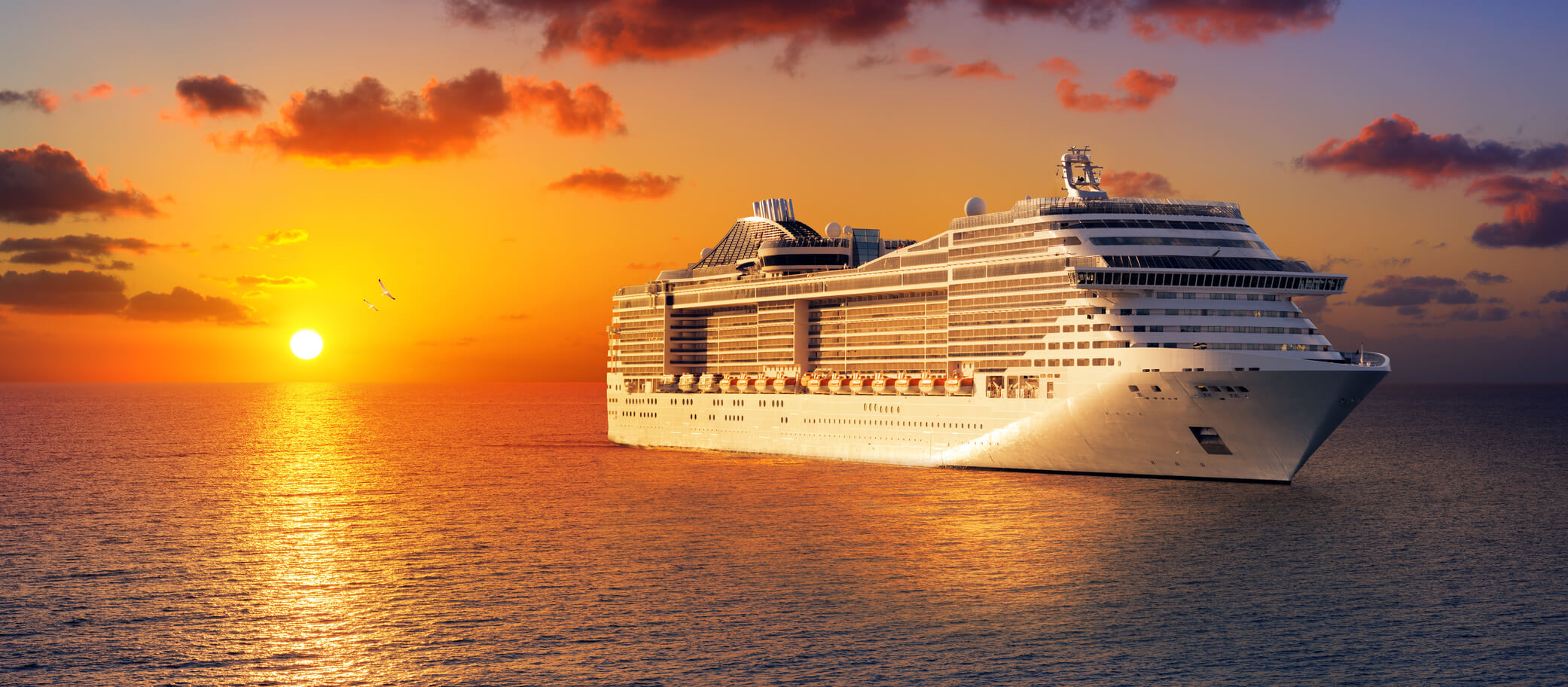 Cruise ship in sunset. Photo by Romolo Tavani